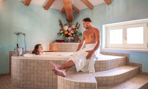 Relaxed couple in a spa with a hot tub.